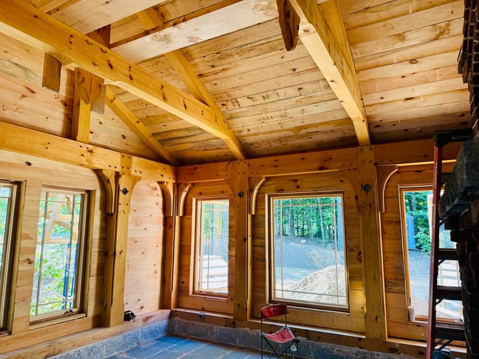Interior timber frame, with sconces in the timbers